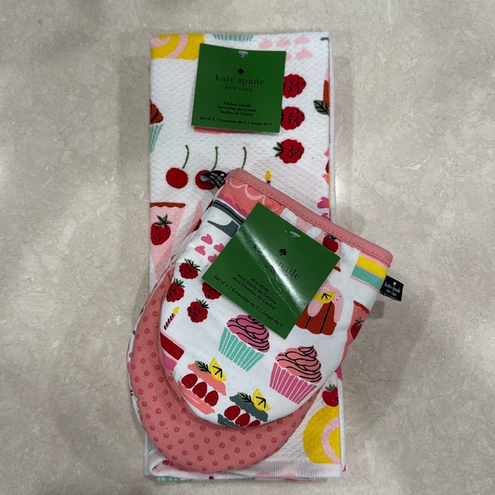 Kate Spade set of three kitchen towels and two oven mitts. Birthday baking theme